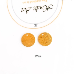 Detail of 12mm gold plated brushed metal circular pendant with pre-drilled hole