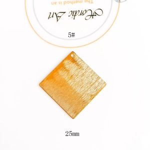 Macro shot of 25mm square gold brushed metal jewelry pendant for DIY earring crafts