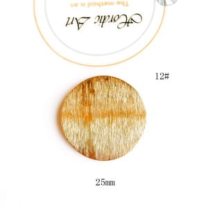 Macro shot of 25mm gold plated geometric round metal pendant with brushed texture