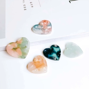 DIY heart-shaped resin charms with marble texture for handmade jewelry making