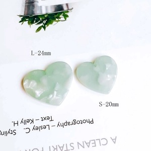 Detail of heart-shaped resin charms in mint green with 20mm and 24mm size measurements