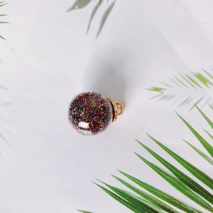 DIY colorful glass ball pendant with vibrant beads and golden metal loop for jewelry