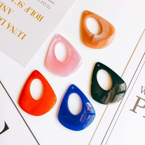 Flat lay of colorful resin teardrop charms with marble texture for DIY earring jewelry making