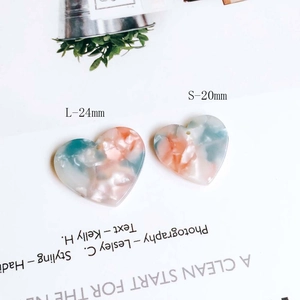 Detail of heart marble resin charms in 24mm and 20mm sizes for DIY jewelry making