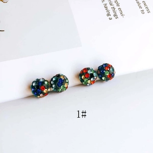 Close-up of sphere stud earrings featuring multi-colored sparkling rhinestones