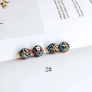 Macro detail of colorful rhinestone encrusted round DIY beads with vertical drill holes