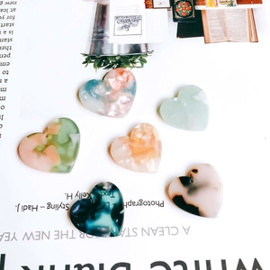 DIY heart-shaped resin charms in marble and tortoiseshell patterns for jewelry making