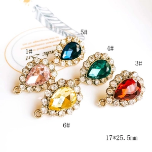 Macro view of colorful teardrop gemstone charms with rhinestones for DIY jewelry making