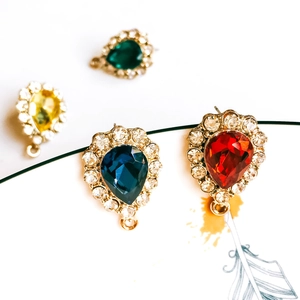 Close-up of teardrop crystal pendants in red blue yellow and green with rhinestone border