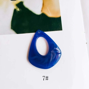 Close-up of geometric hollow teardrop resin pendant with blue marble pattern texture