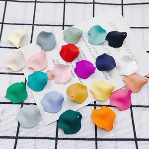 Macro shot of colorful matte resin flower petal pendants with pre-drilled holes for DIY jewelry