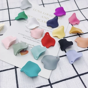 Macro detail of colorful matte resin flower petal charms for DIY jewelry making