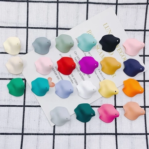 Close-up of matte resin petal-shaped DIY jewelry components in 22 various colors
