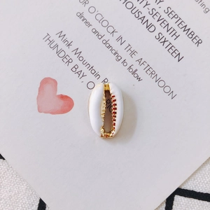 Close-up of white shell pendant with gold plating for DIY jewelry making