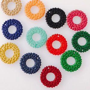Macro shot of colorful rattan-style circular resin pendants for DIY jewelry making