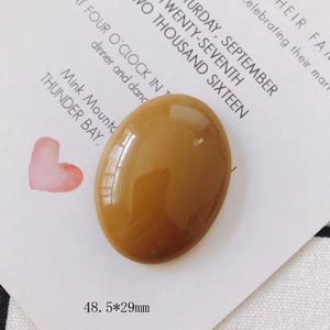 Yellow oval resin pendant stone with polished finish and 48.5x29mm dimensions