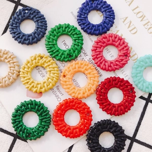 Detail of woven rattan-style hollow circular charms for DIY earring and jewelry making
