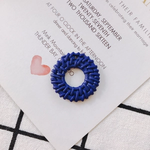 Detail of dark blue hollow round woven rattan accessory with a small connector hole