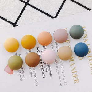 Flat lay of colorful matte resin dome beads for DIY shoe charms and jewelry crafts