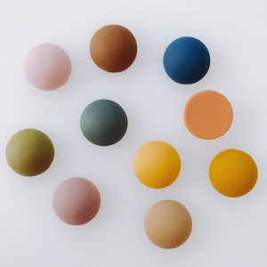 Detailed view of matte resin semi-circular patches in diverse Morandi color tones