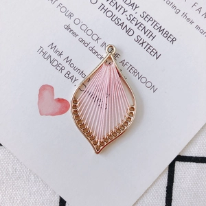 Detail of pink silk thread woven leaf pendant with gold metal frame for DIY jewelry