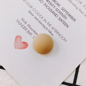 Matte khaki resin dome button accessory for DIY crafts and phone cases on plaid fabric