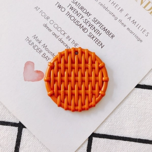 Detailed view of orange resin pendant with woven texture for DIY earring making