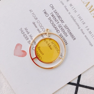 Detail of a bright yellow enamel geometric circle pendant with gold frame for DIY jewelry