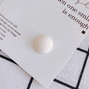 Close-up of white matte resin cabochon bead for DIY shoe charms and phone case decor