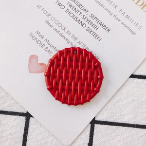 Macro shot of red round resin pendant with woven texture for DIY jewelry making