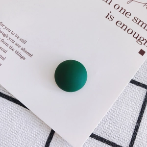 Detail view of dark green matte resin semi-round bead for DIY crafts and jewelry