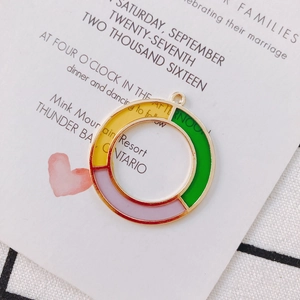 Detailed view of colorful geometric oil-drop round charms for DIY jewelry making