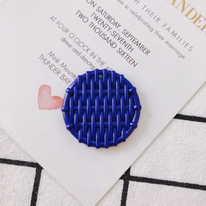 Detailed view of a dark blue round resin pendant with a woven texture for DIY earrings