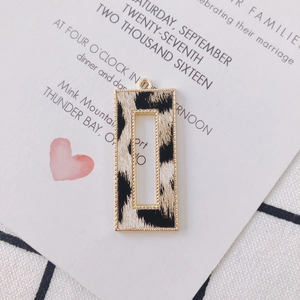 Close-up of golden alloy rectangular leopard print hollow charm for jewelry making