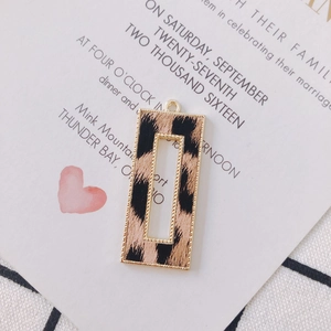 Close-up of rectangular leopard print alloy pendant for jewelry making with hanging loop