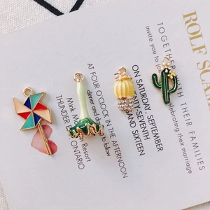 Macro shot of colorful enamel cactus and windmill charms for DIY jewelry making