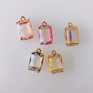Macro view of five colorful square crystal faceted pendants with gold plated claw settings
