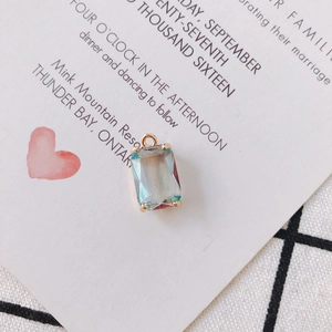 Macro detail of rectangle gradient crystal pendant with gold frame and mounting ring