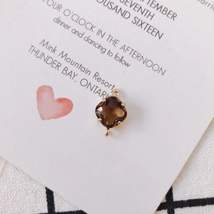 Detail of a brown crystal pendant in a 18k gold-plated double-loop setting for DIY jewelry