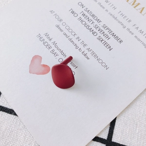 Detail of matte burgundy irregular geometric earrings with 925 silver pins on a card