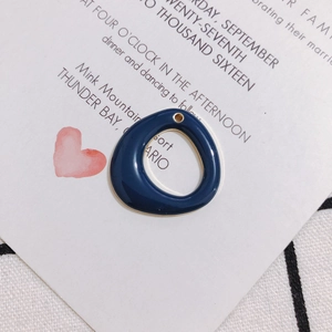 Detail of a dark blue enamel geometric pendant with gold trim for DIY jewelry making
