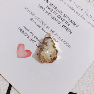 Detail showing irregular white druzy stone pendant with gold edge on elegant card