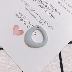 Detail of grey-blue enamel irregular round pendant with gold edge for DIY jewelry making