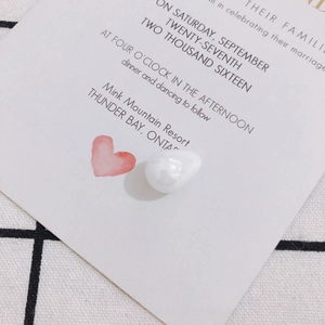 Macro shot of irregular baroque pearl pendant on a decorative heart card for DIY jewelry