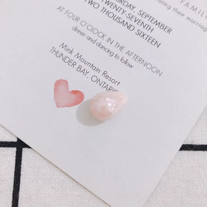 Close-up of pink teardrop faux pearl bead with marble texture for DIY jewelry making