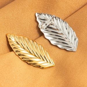 Minimalist stainless steel leaf brooches in gold and silver finish with detailed leaf veins