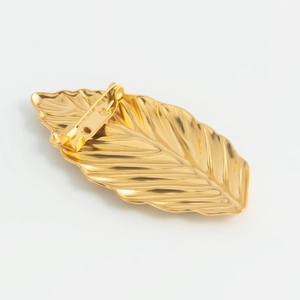 Minimalist leaf brooch in 18K gold plated stainless steel showing the back pin and texture