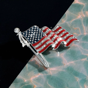 Elegant silver American flag brooch with sparkling rhinestones in a waving design