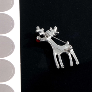 Silver reindeer brooch with red nose and pin clasp, back view of rhinestone lapel pin