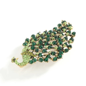 Elegant peacock brooch featuring green rhinestones and a gold-tone metal frame
